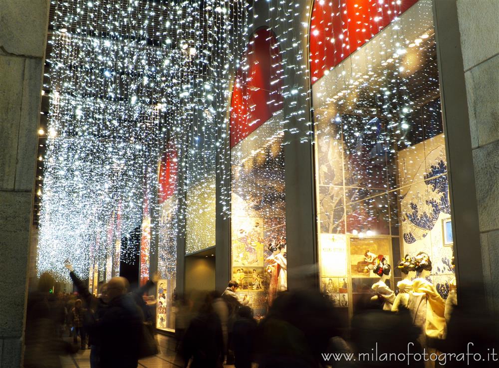 Milan (Italy) - People walking in front of the Rinascente store with christmas lights
